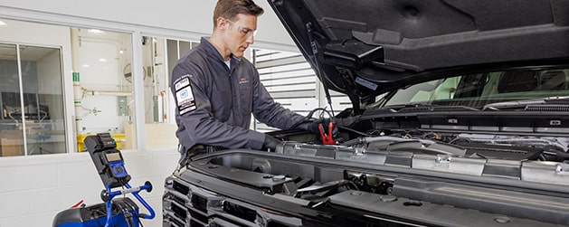 GMC Certified Service Technician Inspecting a Vehicle