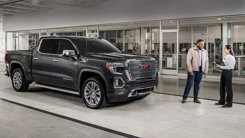 A GMC representative next to a vehicle