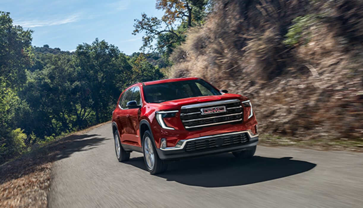 GMC Truck Driving Along a Cliffside Road