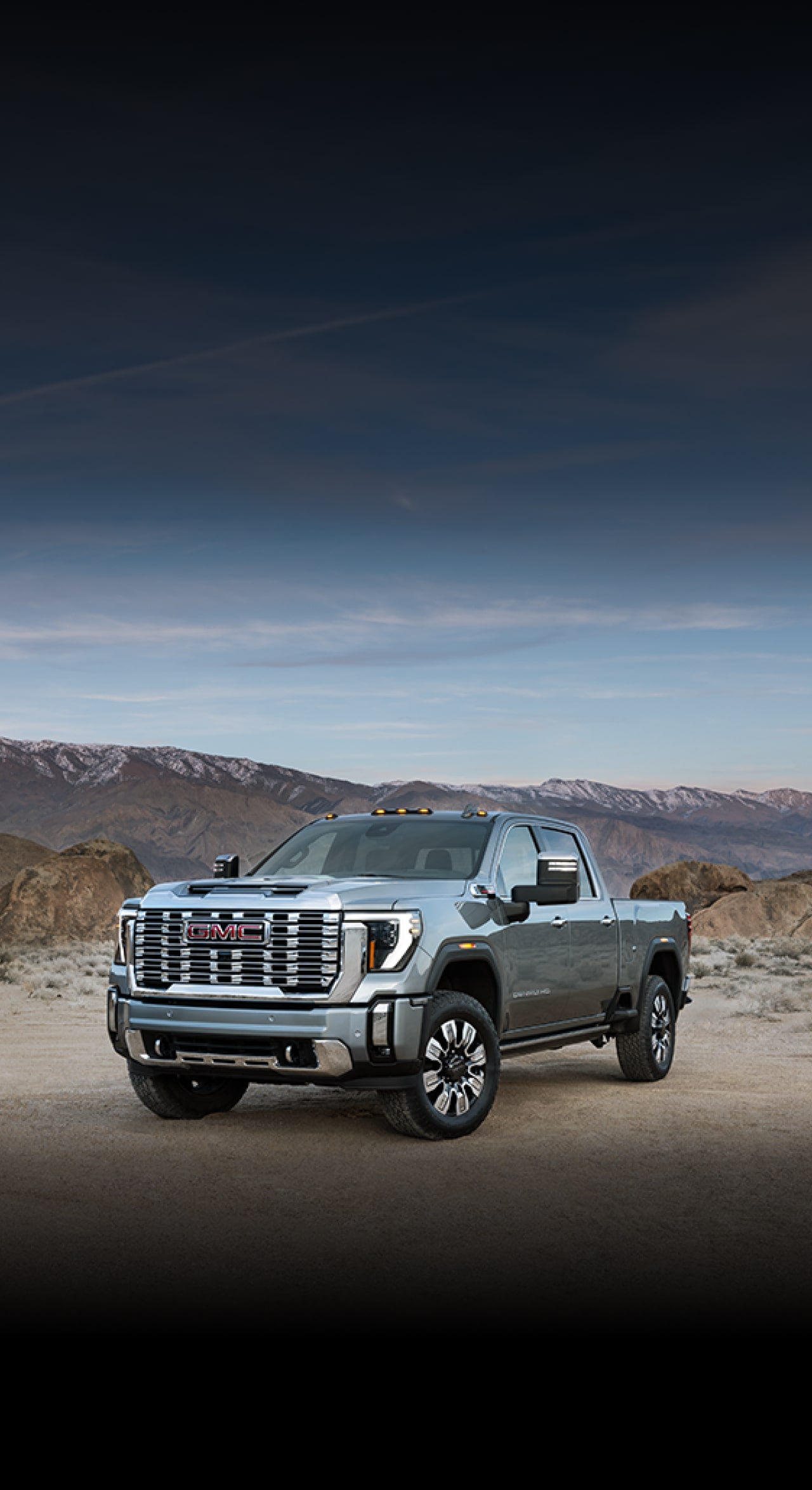 GMC Canyon Models Featuring 3.9% APR with a Gray GMC Canyon Pickup Truck Driving On a Dirt Road Kicking Up Dust