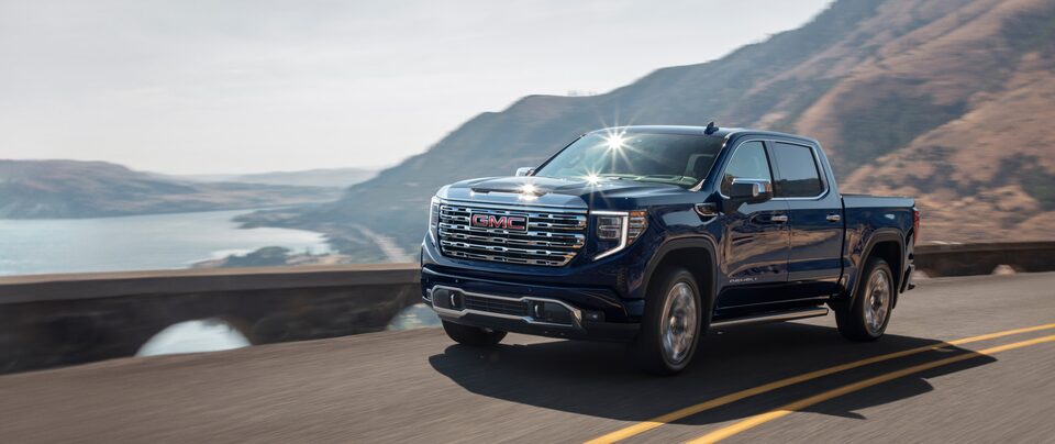 Man Walking Next to GMC Truck in nature