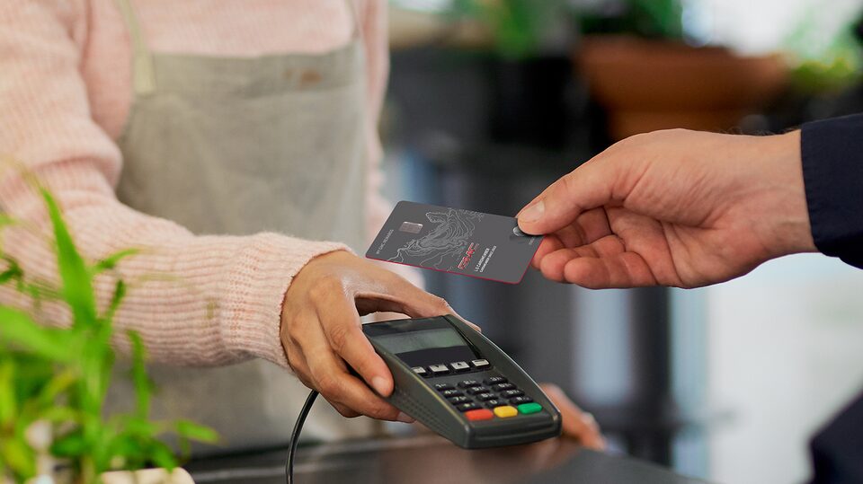 Man Using His My GMC Rewards Card at Coffee Shop to Earn Points