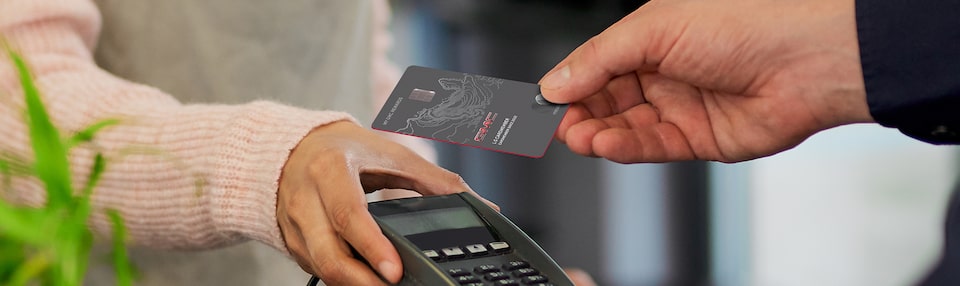 Man Using His My GMC Rewards Card at Coffee Shop to Earn Points