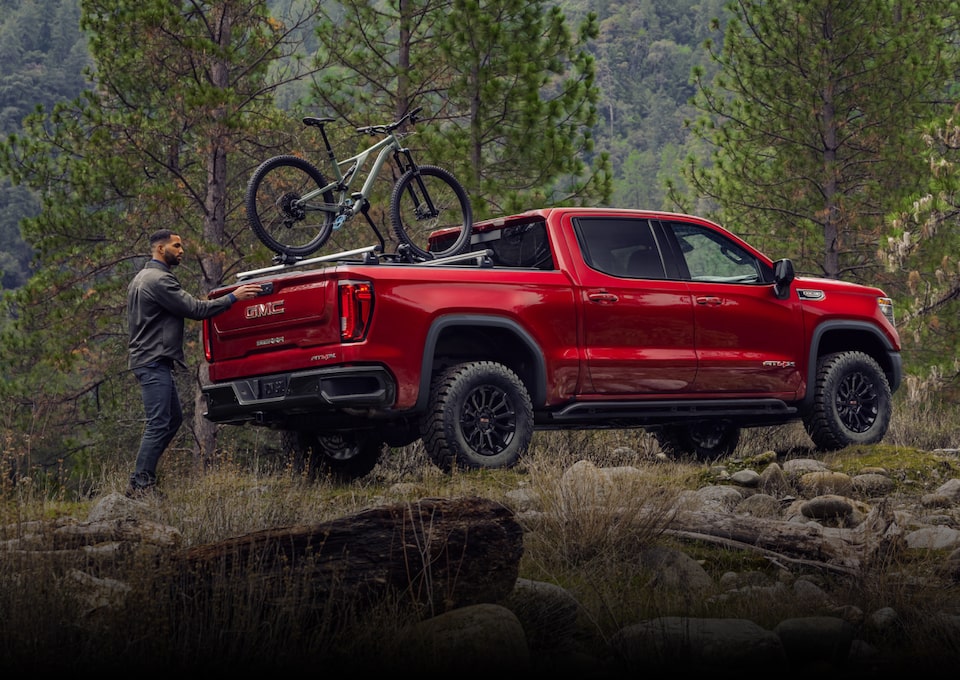 Man putting bikes in the back of his GMC Sierra