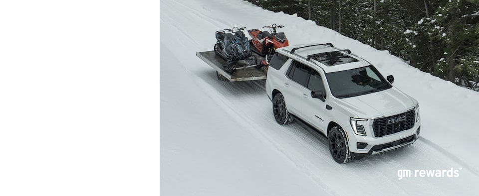 GMC pulling snowmobiles