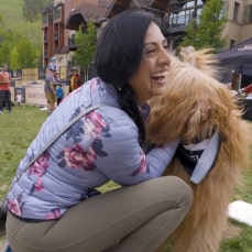 Woman petting dog at GoPro Mountain Games