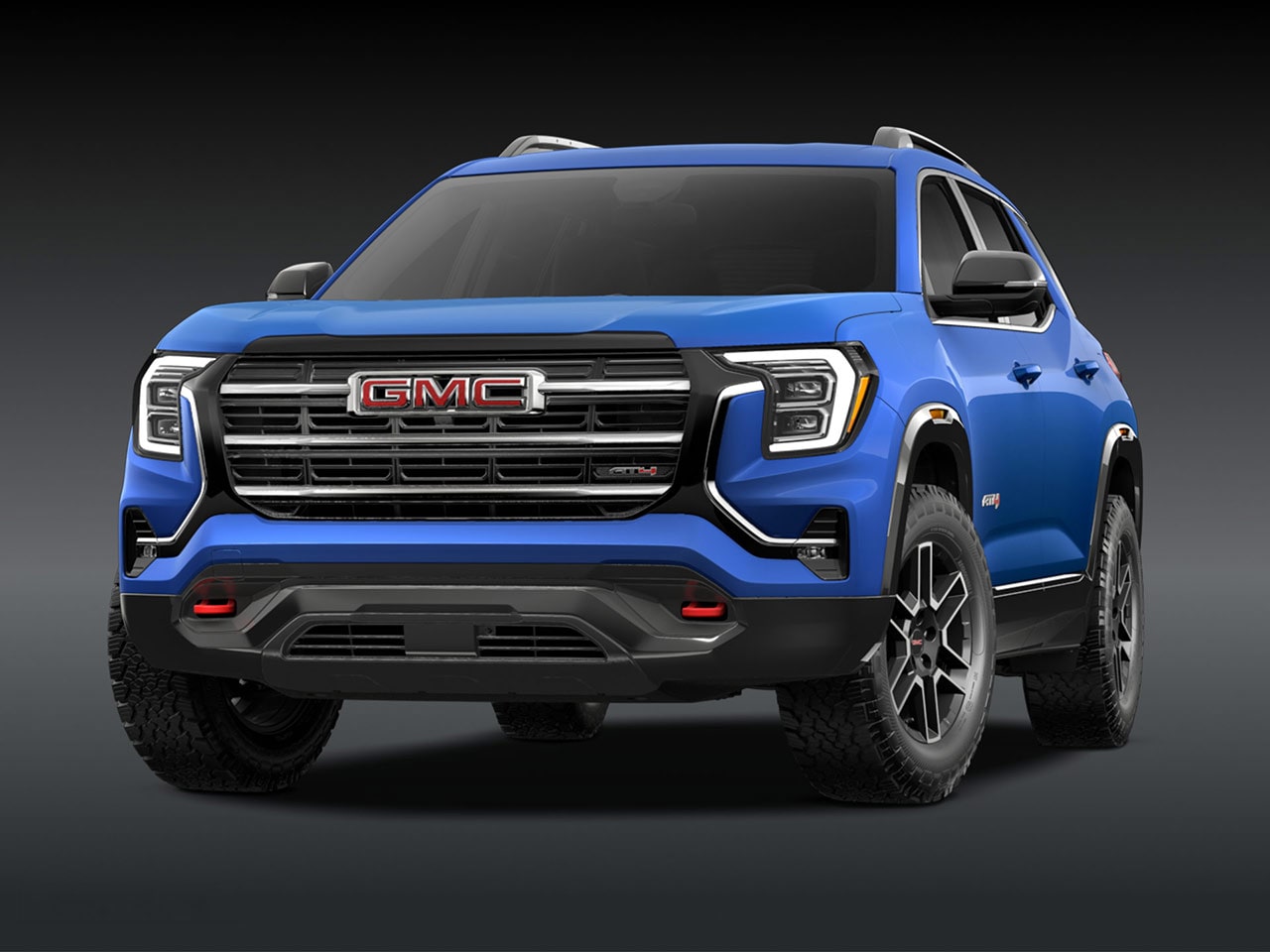 A Front Exterior View of a Bright Blue GMC AT4 SUV with a Prominent Grille Headlights and Rugged Tires