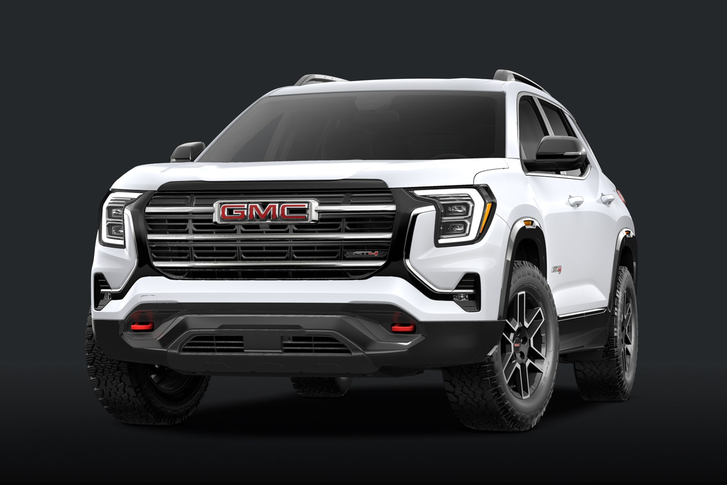 A White GMC AT4 SUV With a Dark Grille and Red Accents Against a Dark Background