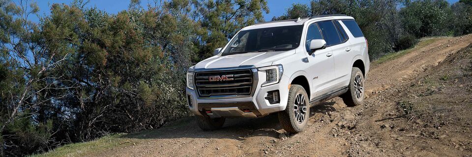 2022 GMC Yukon AT4 Full-Size Off Road SUV Driving Down Dirt Road 