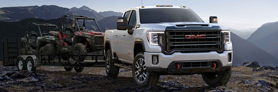 Front three quarter view of 2023 GMC Sierra HD AT4 truck parked on a mountain