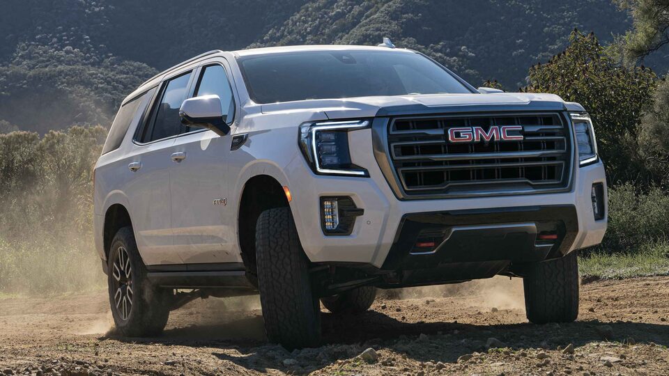 Front three quarter view of 2023 GMC Sierra HD AT4 truck parked on a mountain