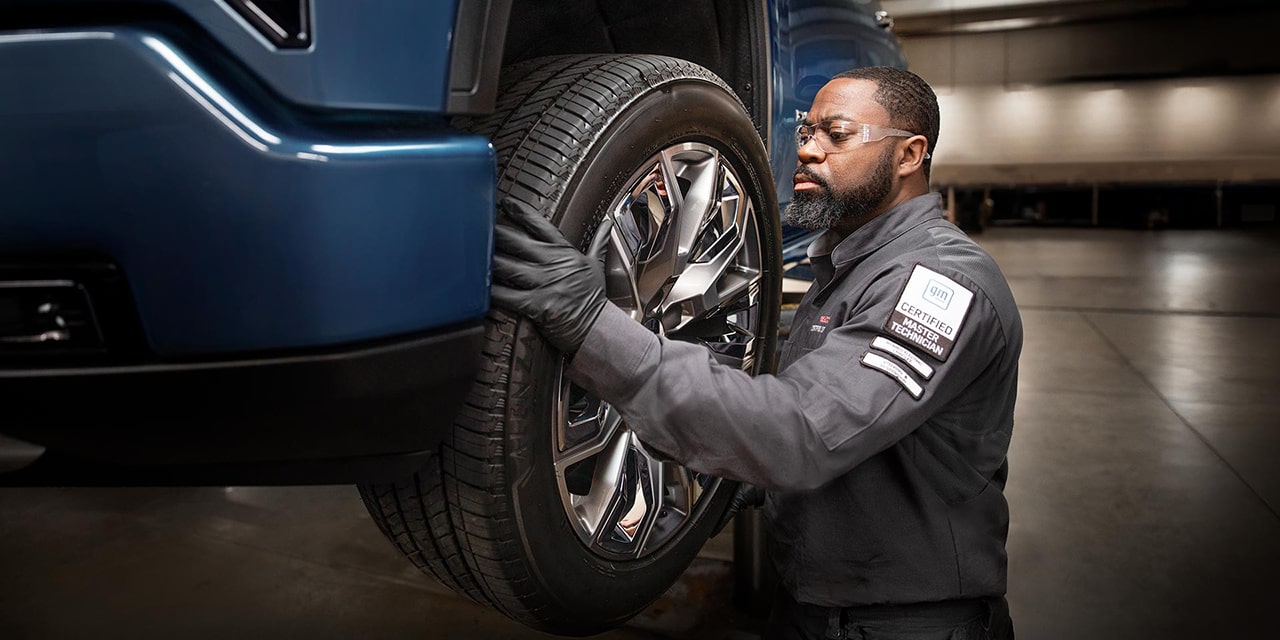 A Mechanic Servicing a GMC Vehicle in an Auto Shop
