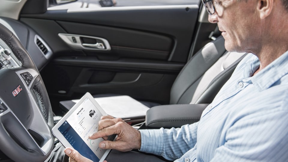 Man using Connected Services on Tablet in 2021 GMC Vehicle