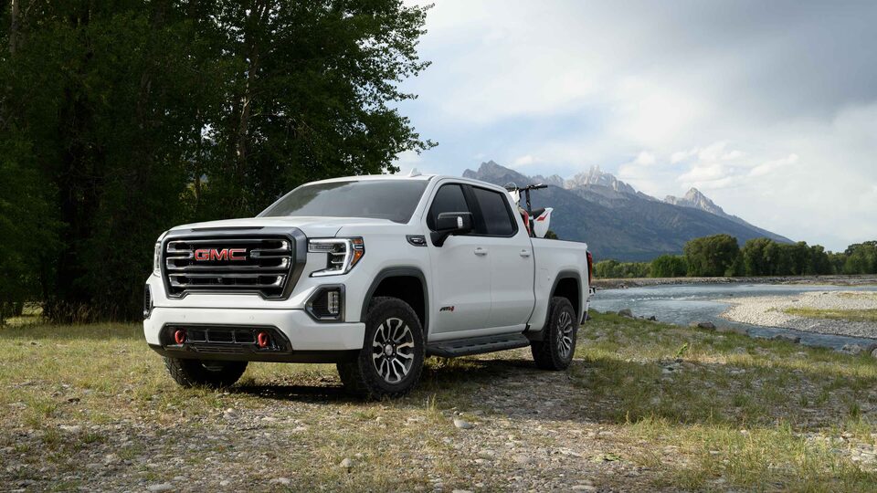 2021 GMC Sierra AT4 Diesel parked in front of Mountain
