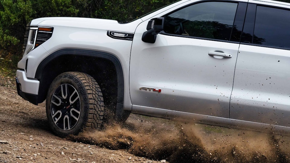 2023 GMC Sierra AT4 Diesel driving on dirt mountain side