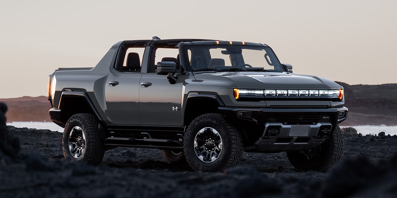 Front Three-Quarter View of the GMC HUMMER EV Pickup Truck Parked on Rough Terrain