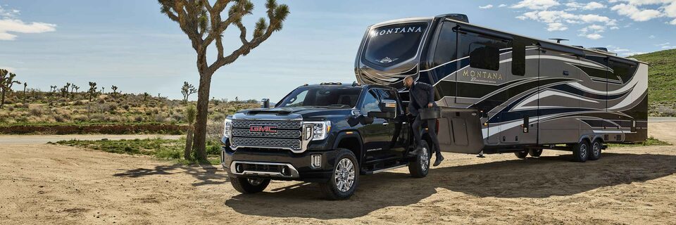 2021 GMC Sierra HD Heavy Duty Truck parked with camper