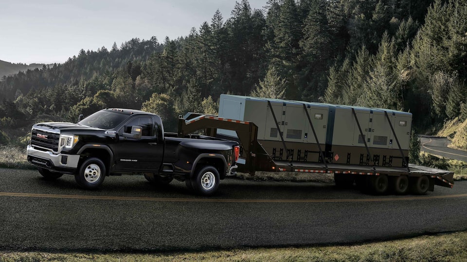 2021 GMC Sierra HD Heavy Duty Truck towing trailer up hill