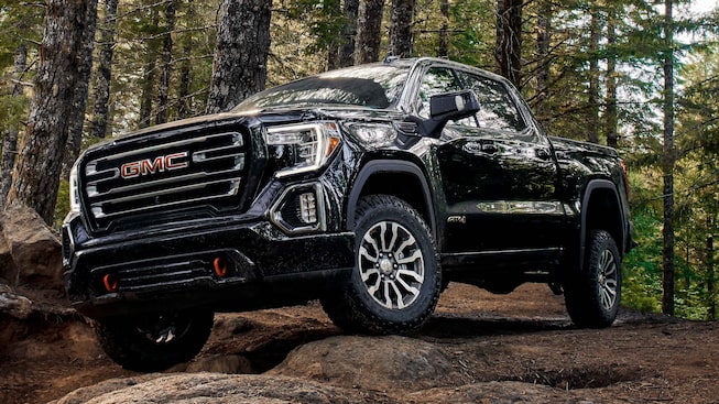 2021 GMC Sierra 1500 AT4 Off-Road Truck driving off-road in forest