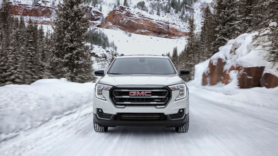2022 GMC AT4 Small SUV Driving on Snowy Road - Front View