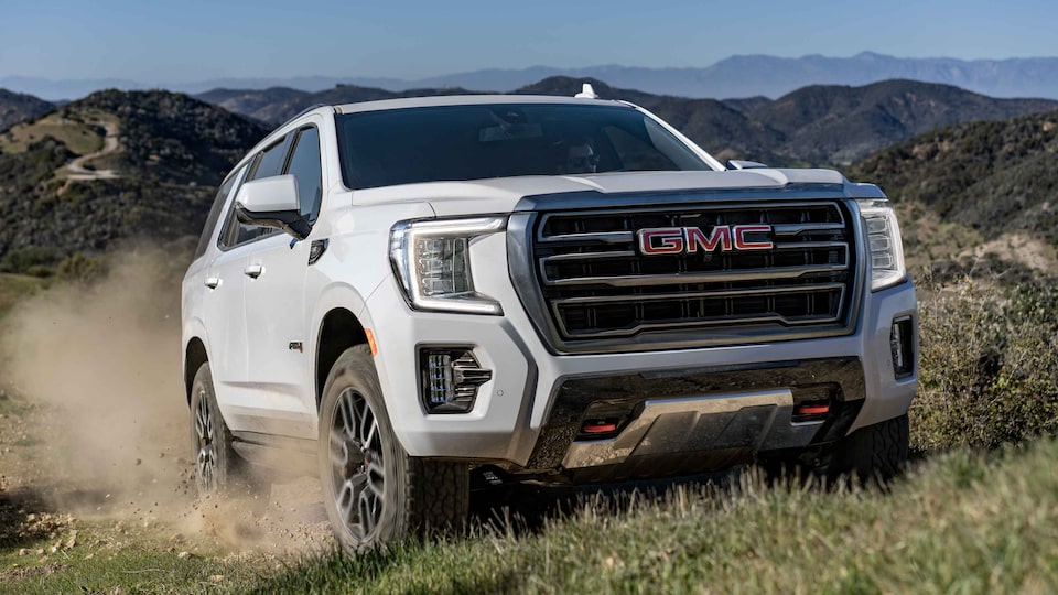 2022 GMC Yukon Three-Quarters View Driving through Rough Terrain