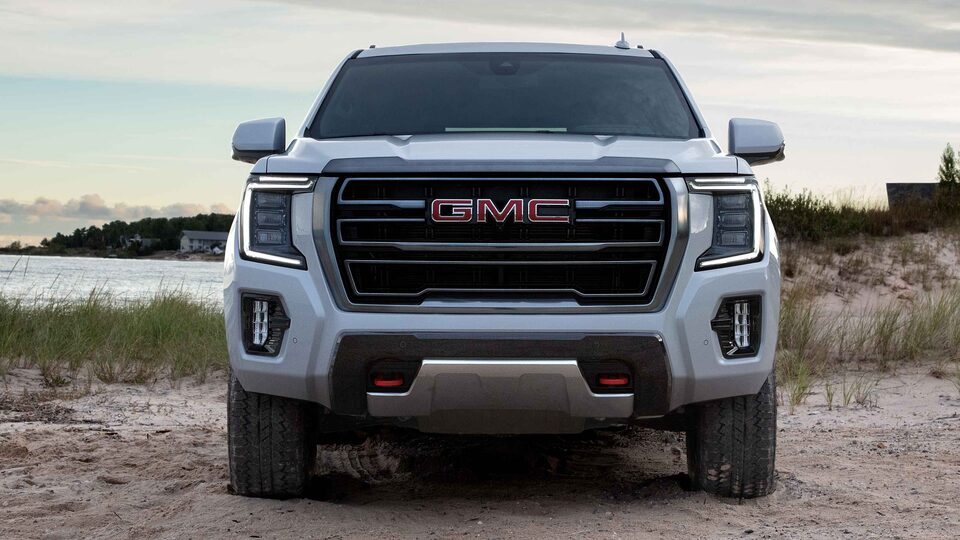 Front view of a 2022 GMC Yukon SUV parked on sandy path