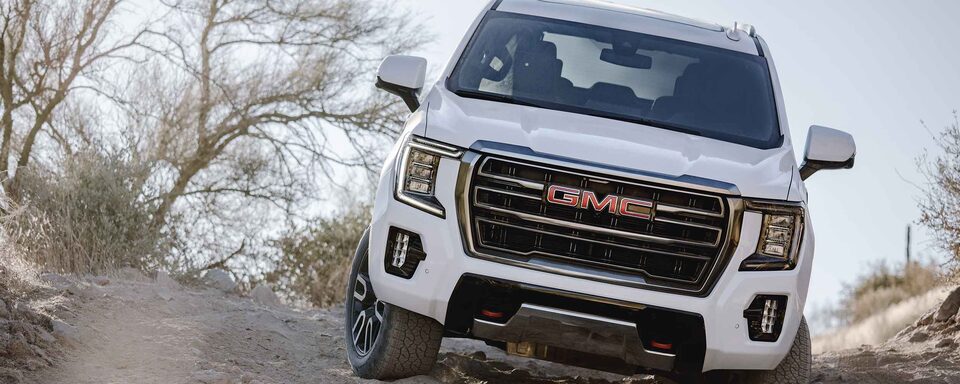 2022 GMC Yukon AT4 Full-Size Off-Road SUV Driving Down Rocks