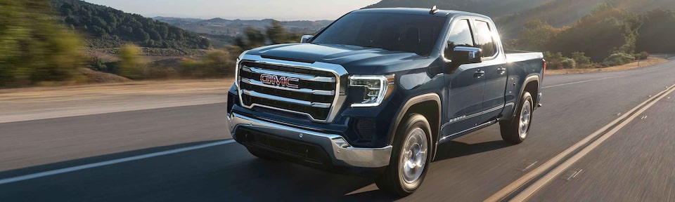 GMC Sierra 1500 Driving Across Open Road