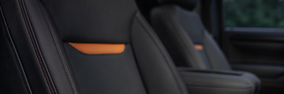 Closeup on Stiched Leather Interior With Orange Accents on the GMC Sierra Pickup Truck