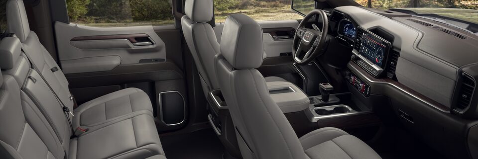 Leather Interior Seating on the GMC Sierra Parked Off-Road With Trees