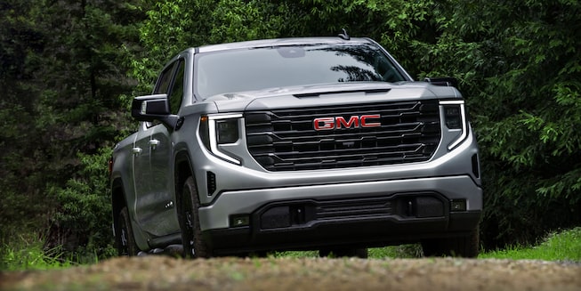 Quicksilver Metallic GMC Sierra SLE/SLT Driving Off-Road in Forest