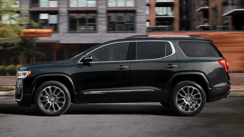 New GMC Acadia Denali Driving On-Road With Buildings