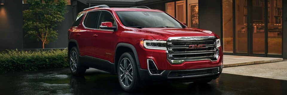 New GMC Acadia Parked In Driveway with House