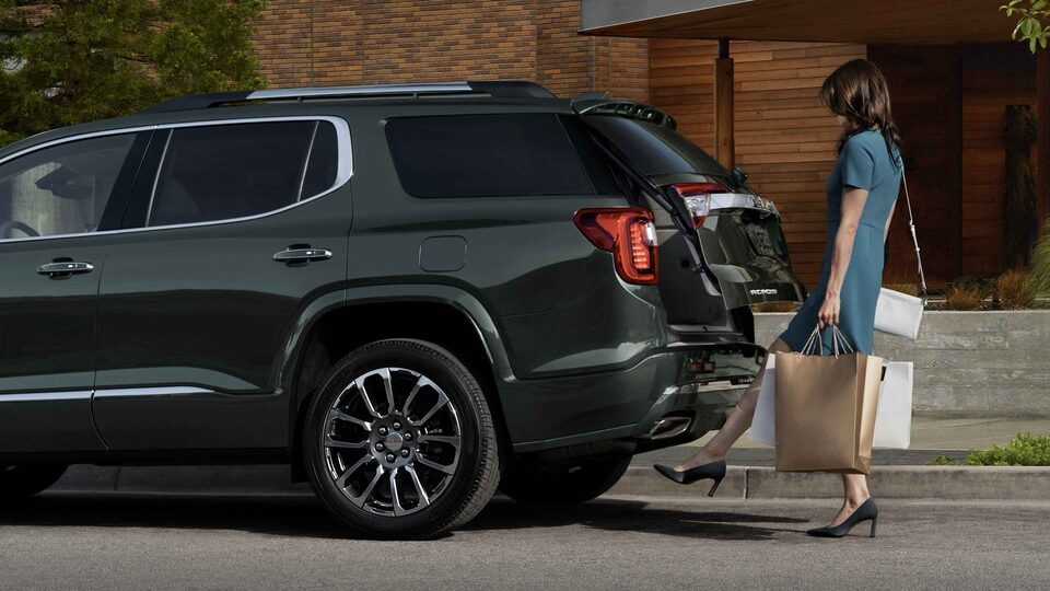 2023 GMC Acadia Denali Mid-Size Luxury SUV with woman using rear lift gate