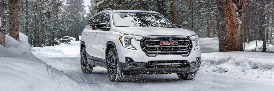 The Striking Summit White GMC Terrain Driving Off-Road on the Snow
