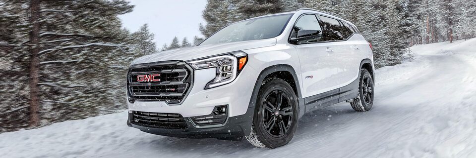The Summit White GMC terrain Driving Off-road On Snow Through the Forest