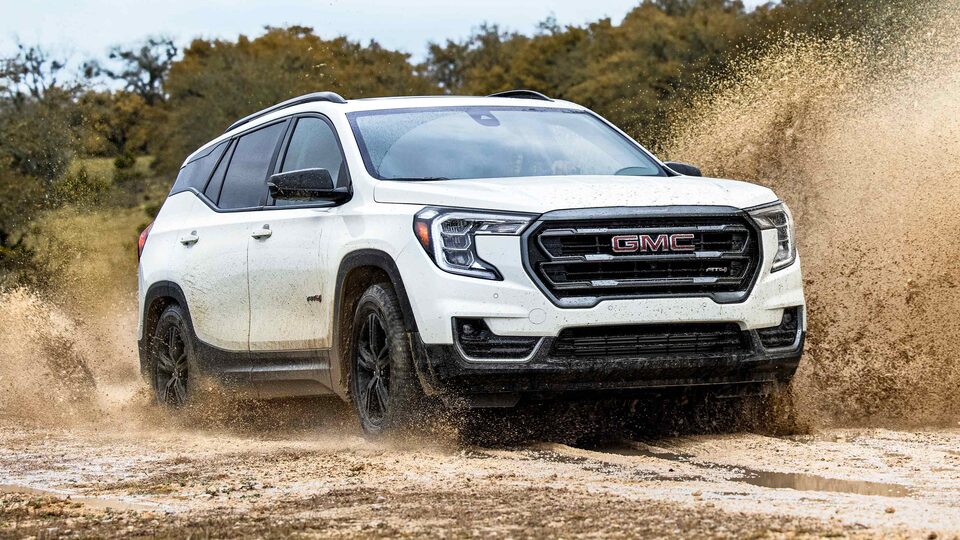 Summit White GMC Terrain Driving Off-Road Through Mud