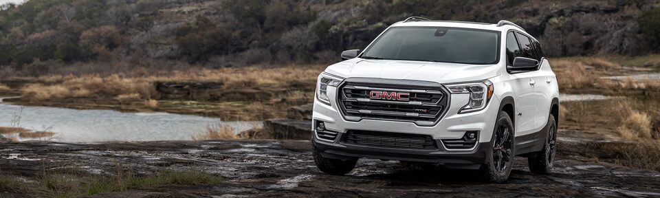 Summit White GMC Terrain Driving Off-Road Through Mud