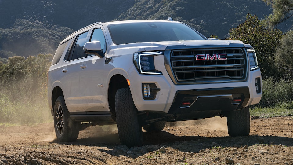 2022 GMC Yukon AT4  Full-Size Off-Road SUV Driving Over Rocks