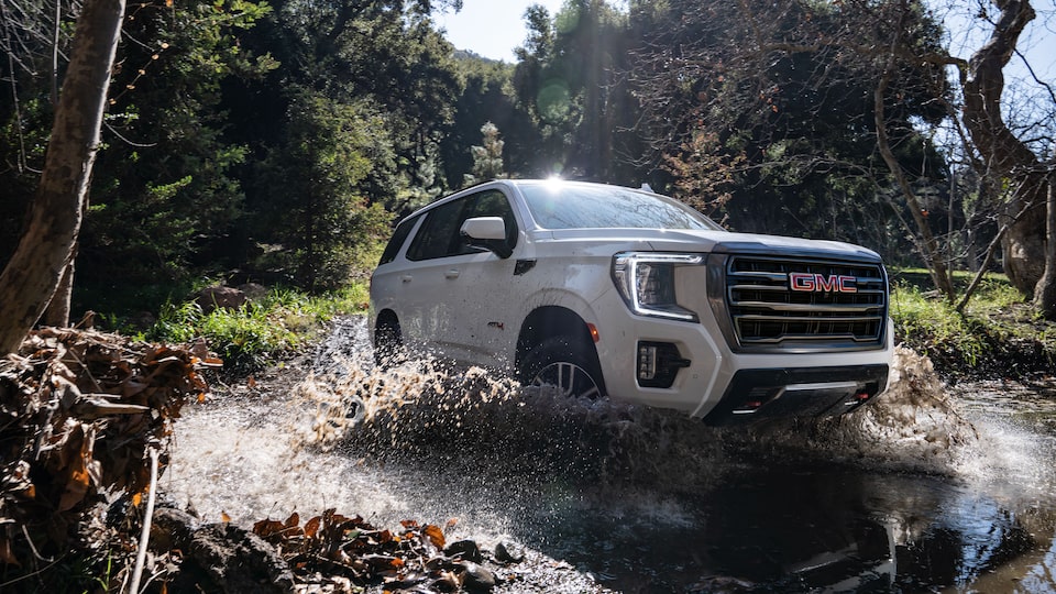 2022 GMC Yukon AT4 Full-Size Off-Road SUV Driving Up Dirt Hill