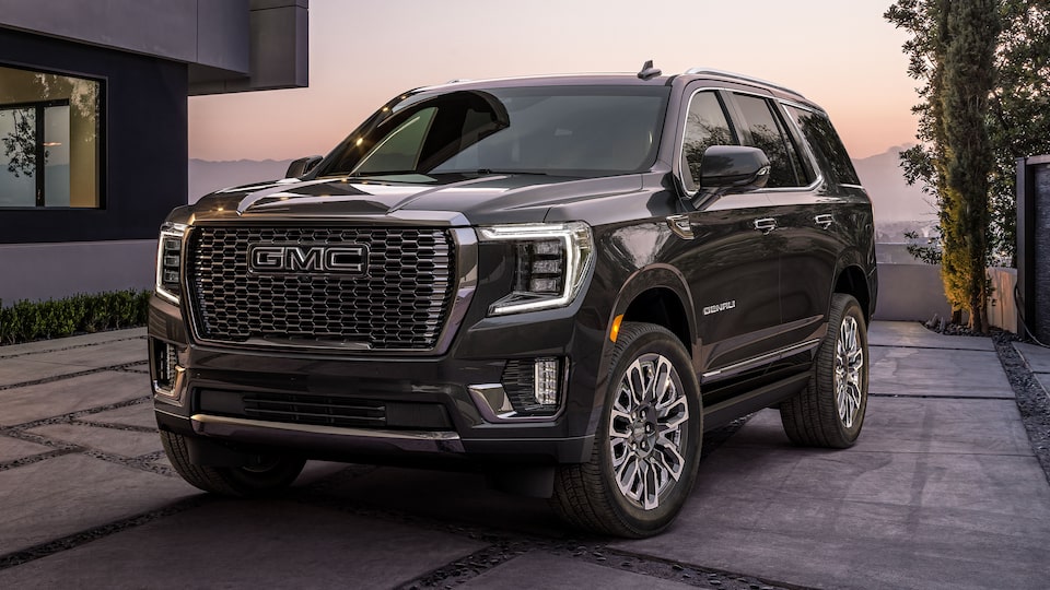 Onyx Black GMC Yukon Parked On-Road In Driveway Next to House