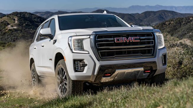 The Stunning GMC Yukon AT4 Driving Uphill Kicking Up Dust