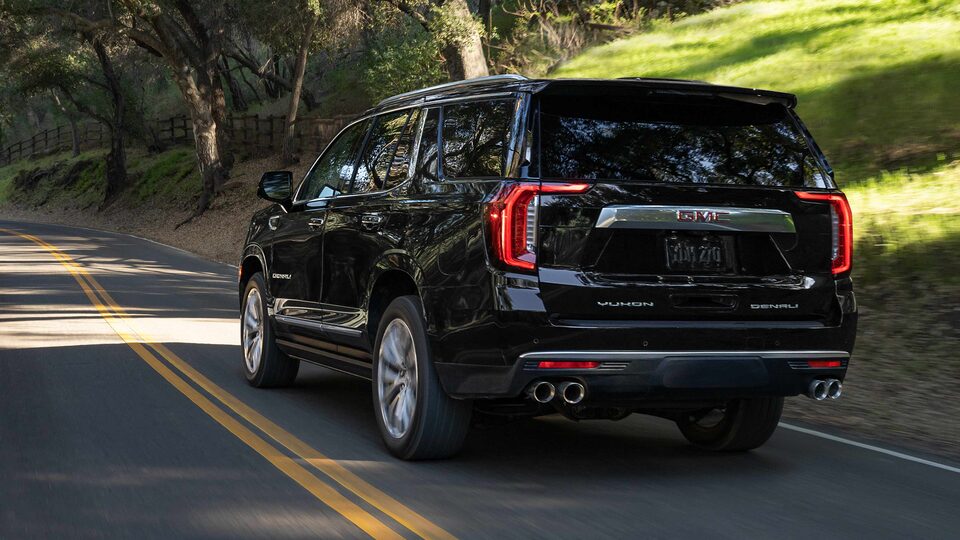 The GMC Yukon Driving On-Road With Trees and Grass
