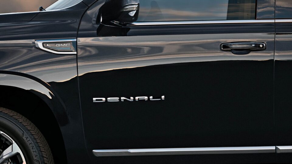 Closeup on the Driver's Side Door and Nameplate of the Onyx Black GMC Yukon Denali
