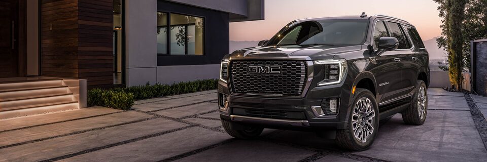 The GMC Yukon Denali Ultimate Parked in the Driveway Next to the House