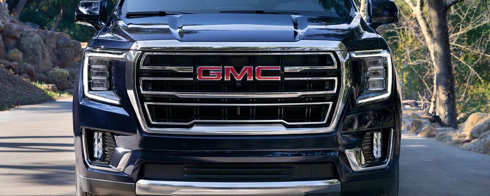 2022 GMC Yukon SLT Full-Size SUV Driving on Road - Front Grille View
