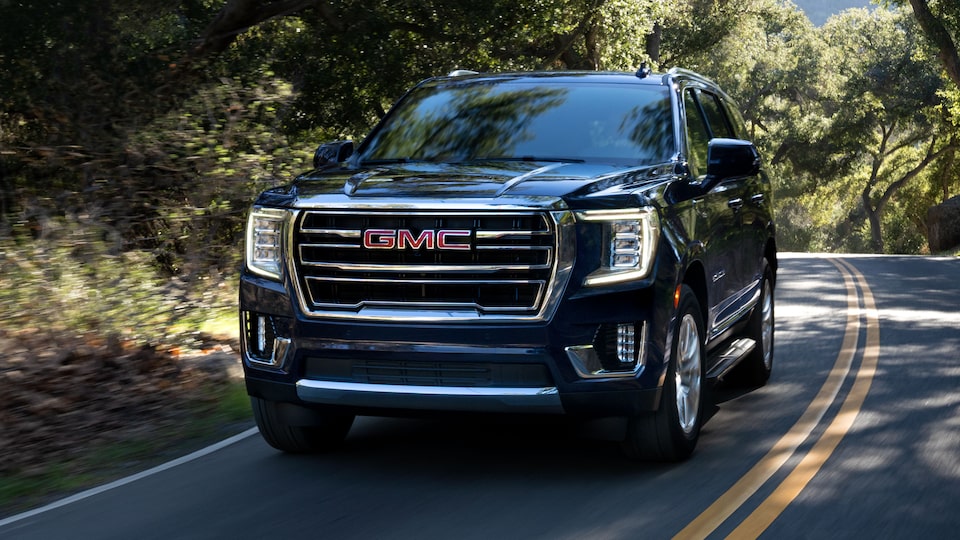 2022 GMC Yukon SLT Full-Size SUV Driving on Road - Front Side View