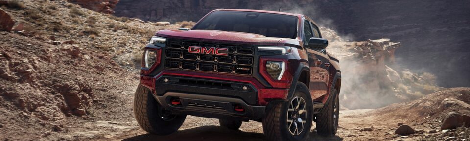 The Canyon AT4X Kipping Up Dirt While Off-Roading in the Mountains 