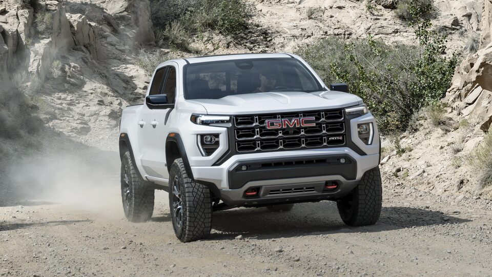 The White GMC  Canyon AT4 Driving Off-Road On a Dirt Path