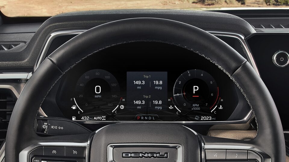 A Closeup of the Steering Wheel and Display for the Driver on the GMC Canyon Denali